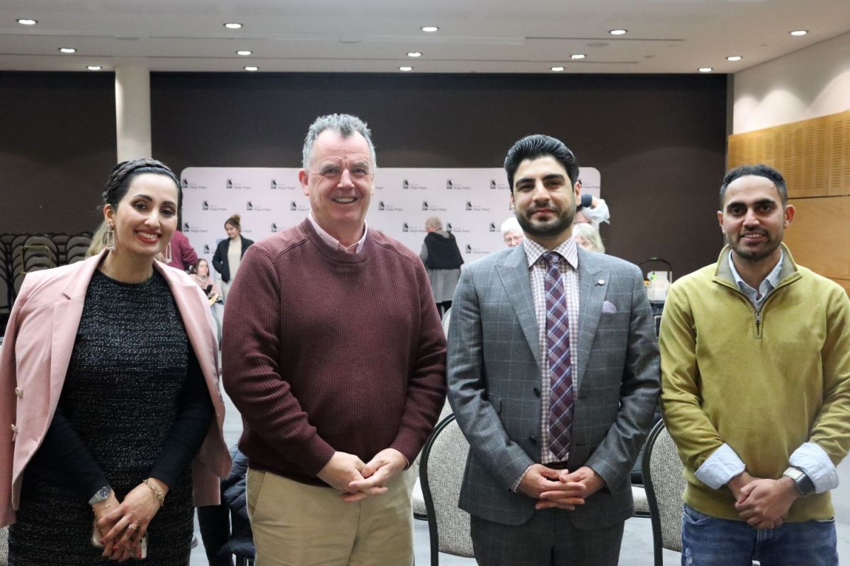 Keynote speaker Tariq Kareemi and partner Shahri Rafi with Mayor Cr Dallas Tout and Ali Hamza (emcee)., standing in a line and smiling at camera. 