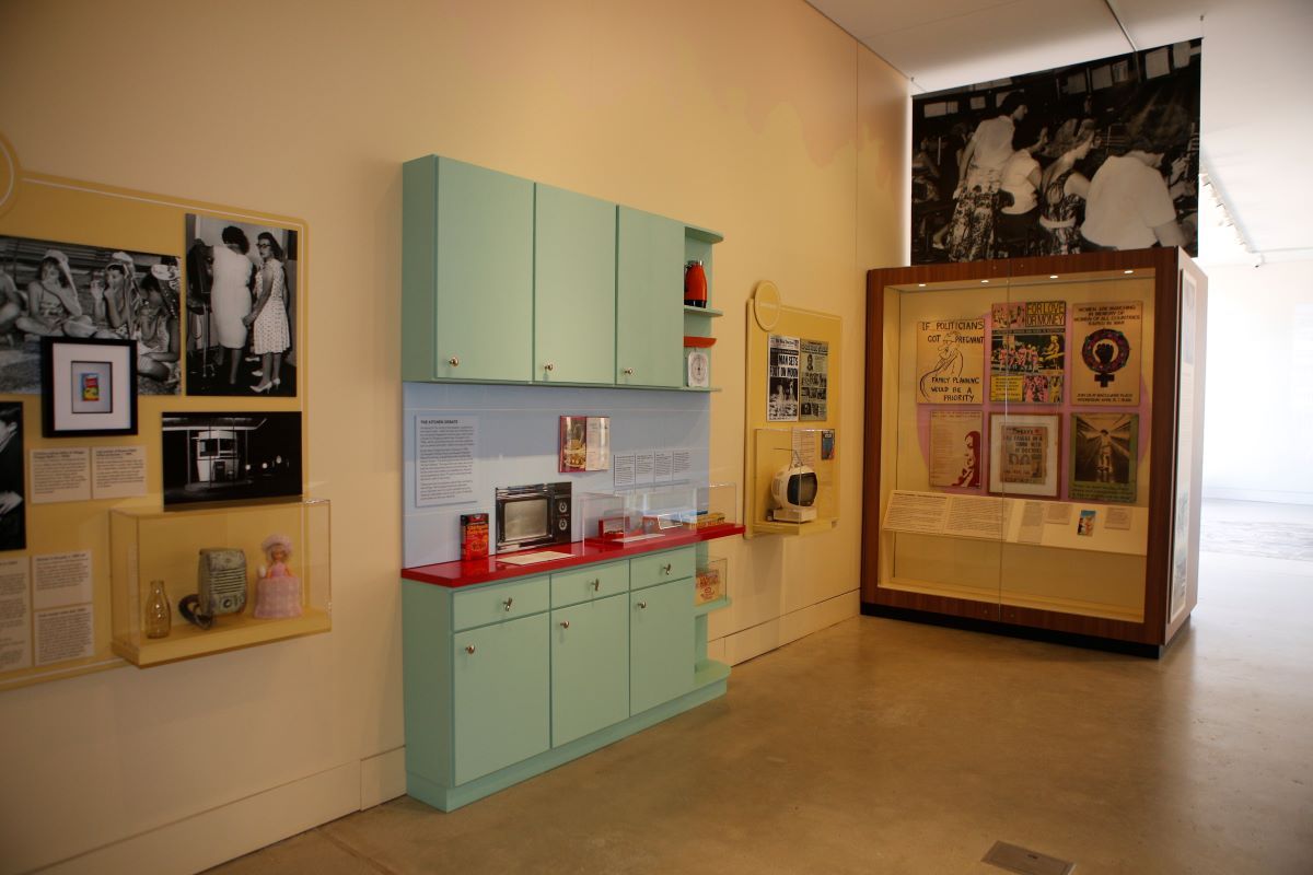 The interior of a museum looking at a display of a 50's style kitchen. 