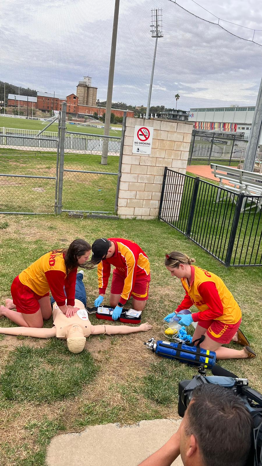 Three Oasis lifeguards and swimming teachers working on a dummy during a water rescue and resuscitation simulation.