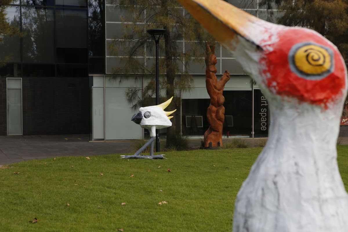 Two bird sculptures stand on the grassed area outside Wagga Wagga Art Gallery’s E3 art space.