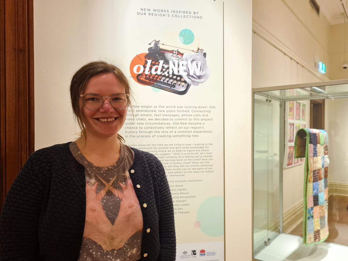 woman in front of exhibition pieces at Museum of Riverina 