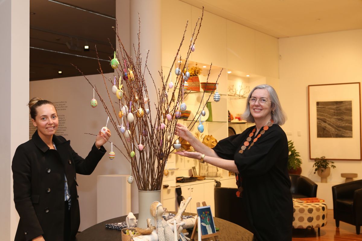 Two women standing either side of an Easter display