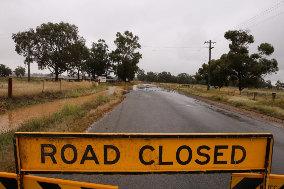 road closed sign flooded road