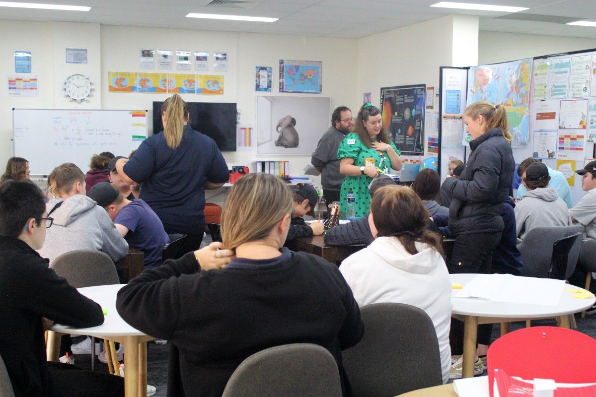 A room full of high school students with Council staff