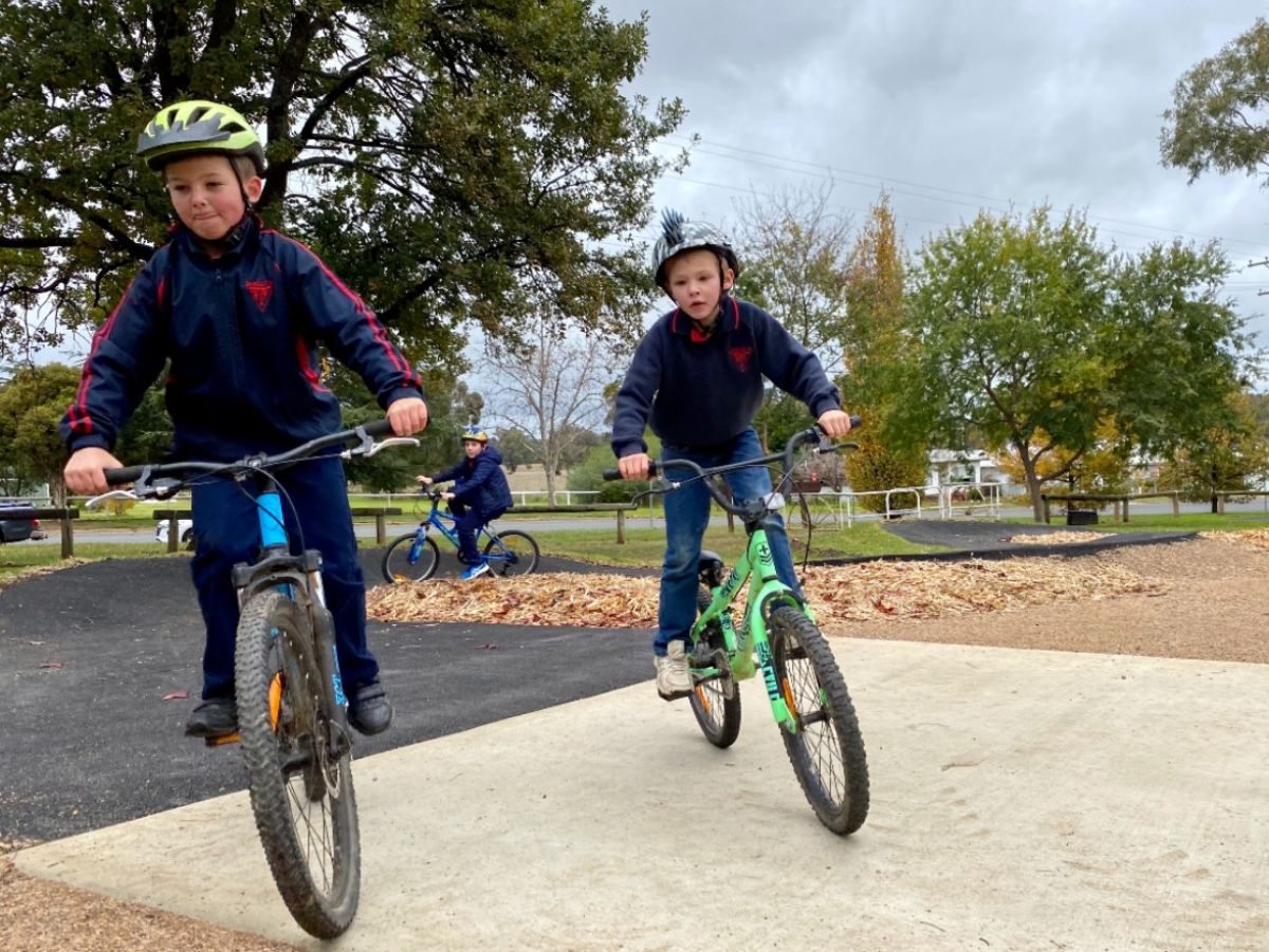 Two primary students riding bikes