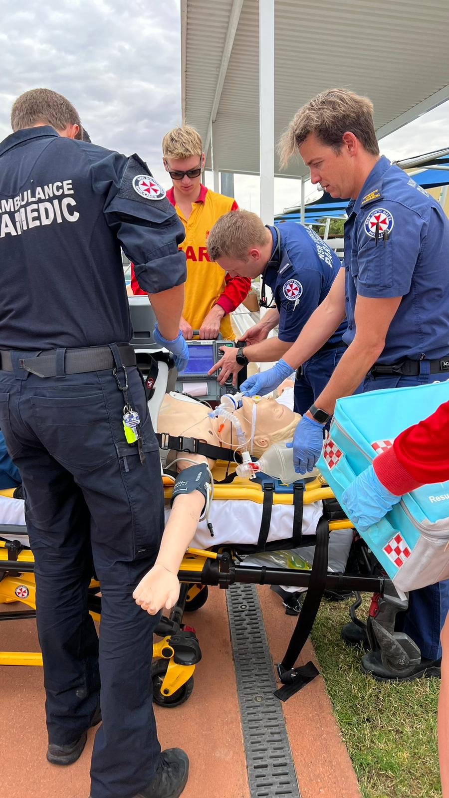 NSW Ambulance paramedics training Oasis staff during a water rescue and resuscitation simulation.