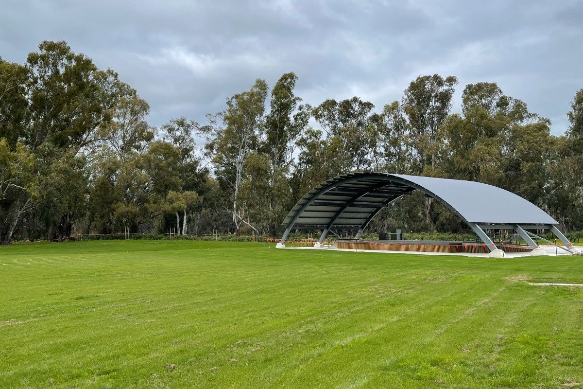 Large grassed area in front of a stage structure at the Riverside precinct in Wagga.