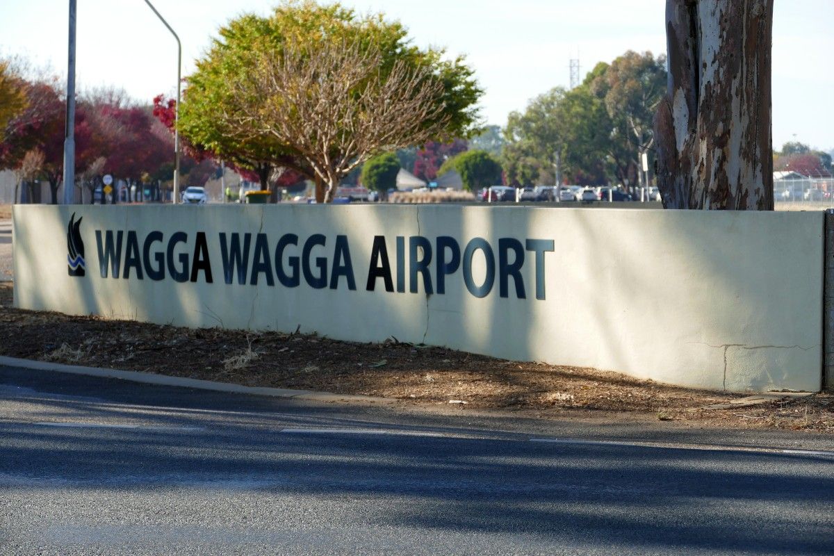 Wagga Wagga Airport sign on concrete wall at entry to airport.