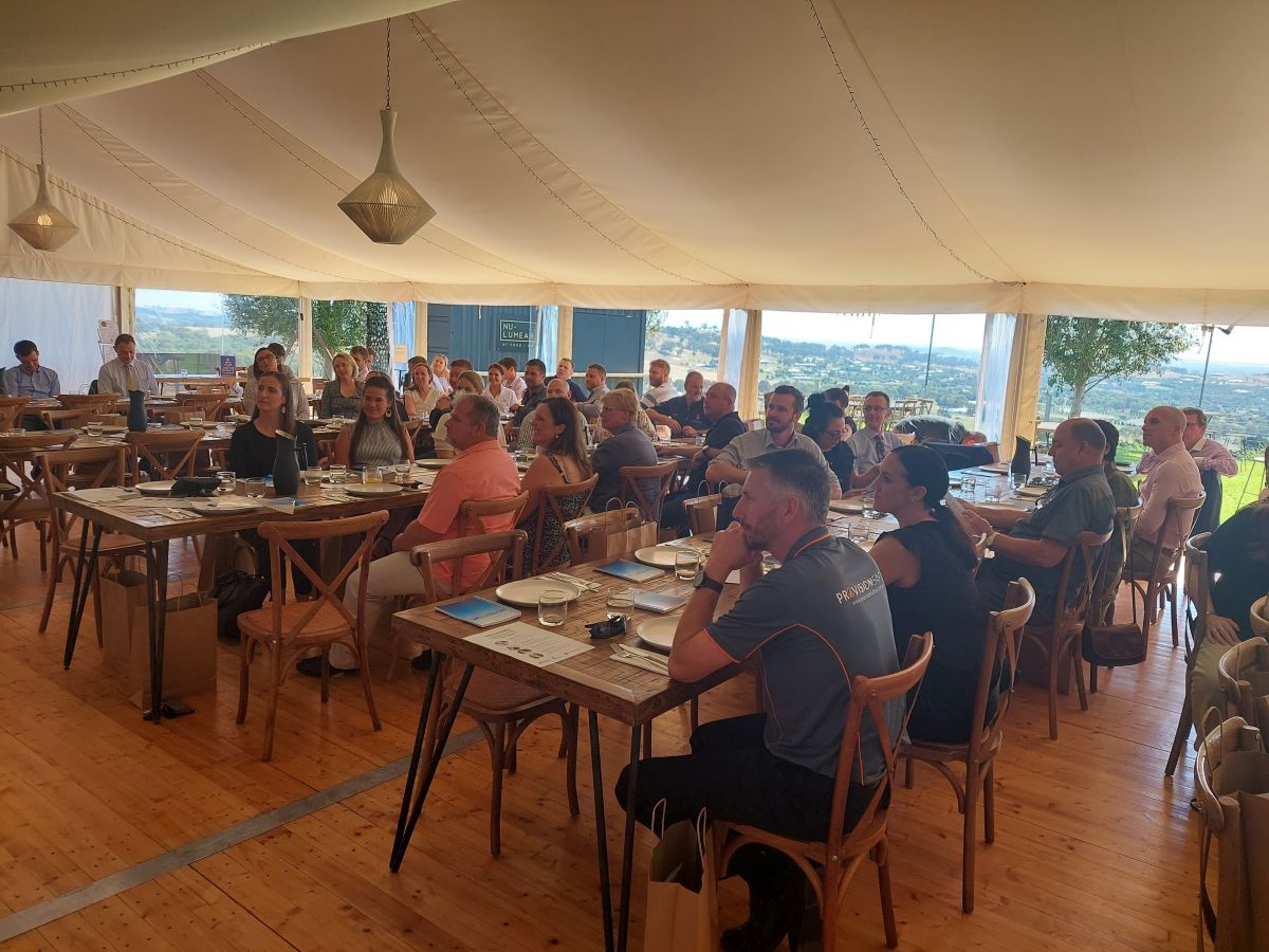 Group of people sitting in a marquee