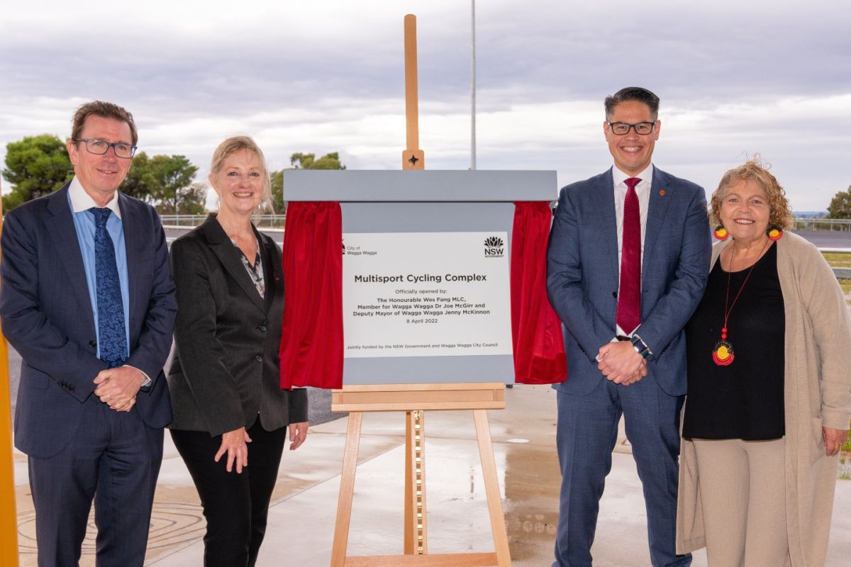 Two men and two woman standing around unveiled plaque