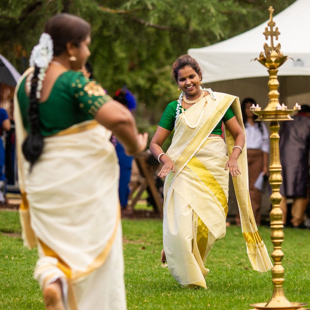 Three women from Kerala Dance Troupe dancing at FUSION 22