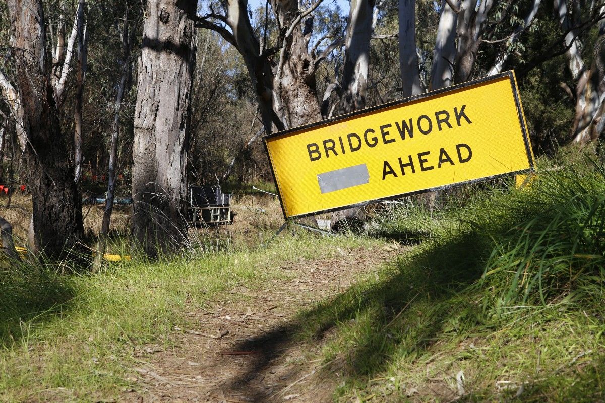 Bridgework sign with lagoon in background
