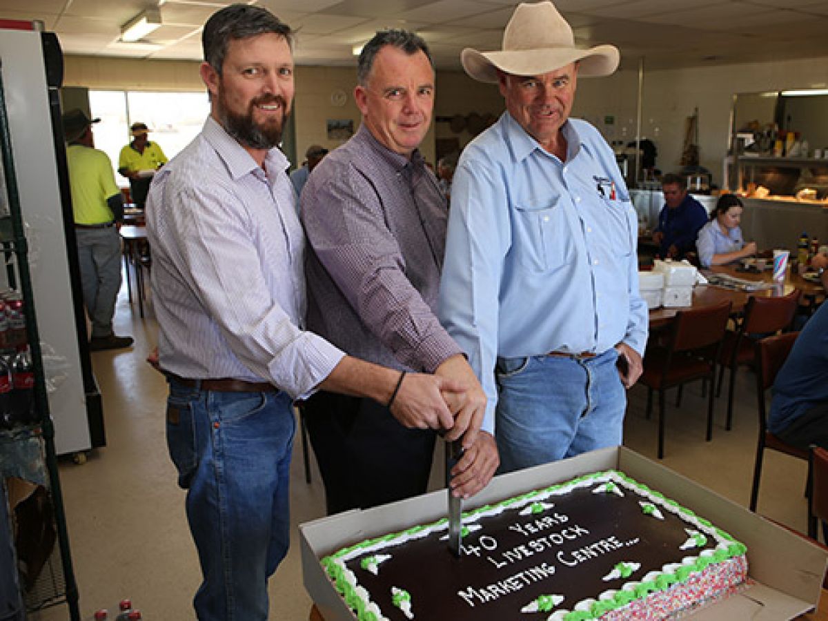 FORTY MILESTONE: Livestock Marketing Centre Manager Paul Martin (left) with Wagga Deputy Mayor Dallas Tout and President of Wagga Associated Livestock Agents Ryan Schiller perform the official cake cutting to mark 40 years since the centre opened for business sin 1979.