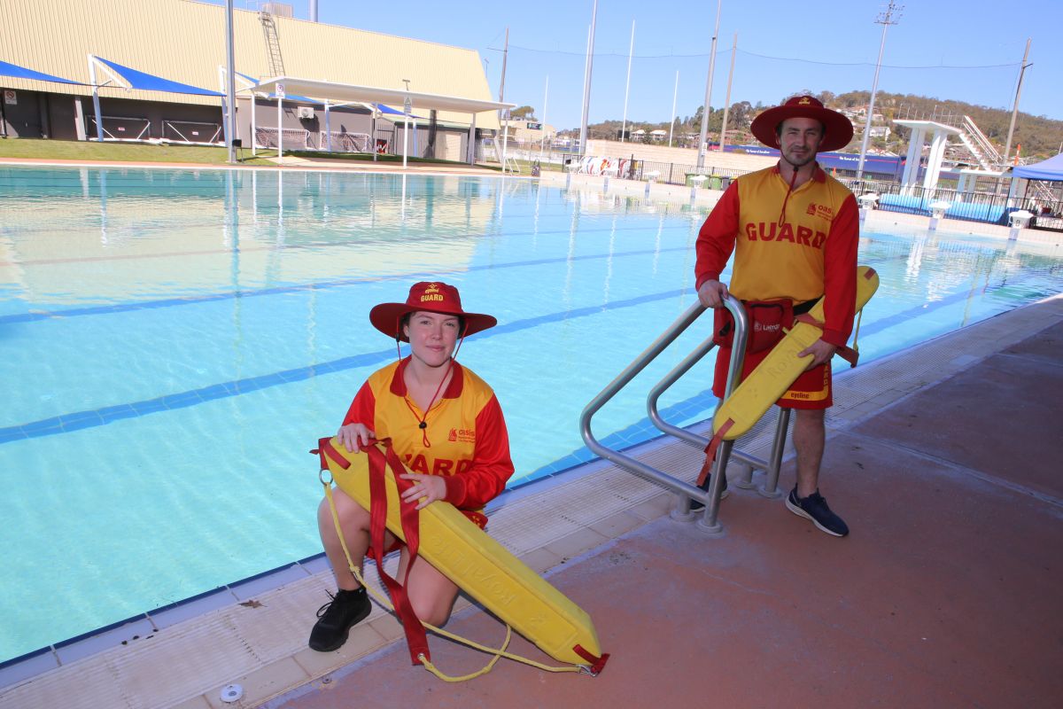 Life guards on edge of swimming pool at Oasis