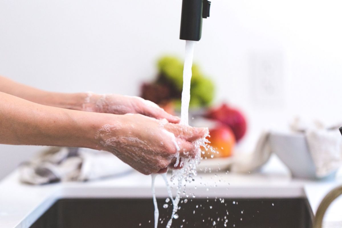 Hands held under running water