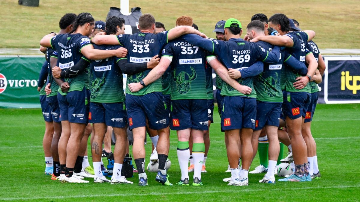 Raiders players in huddle at McDonalds Park