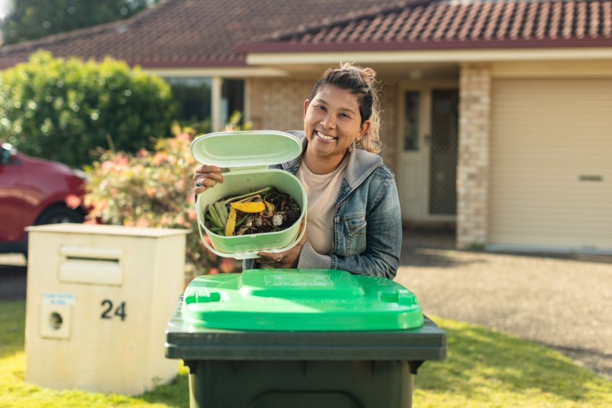 Woman holding FOGO bin