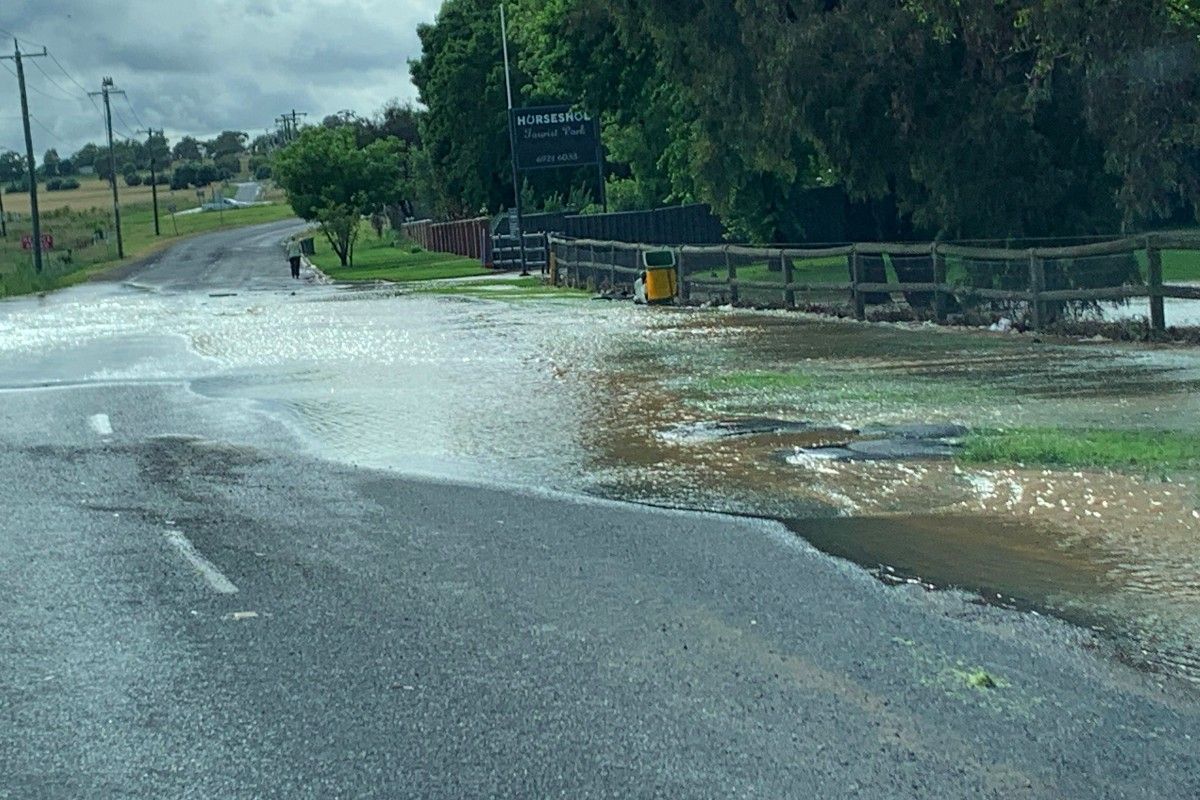 Flash flooding water flowing across Horseshoe Road in North Wagga