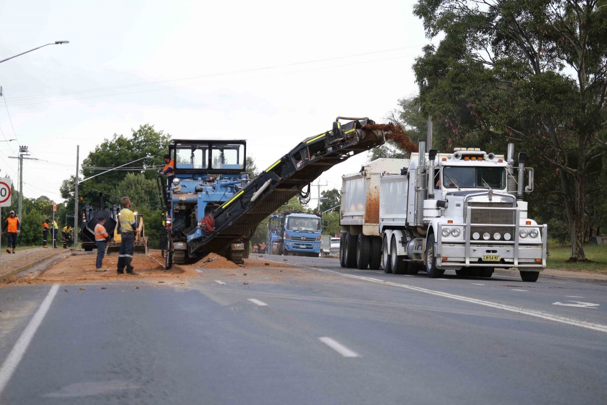Road construction machinery and truck working on Lake Albert Road