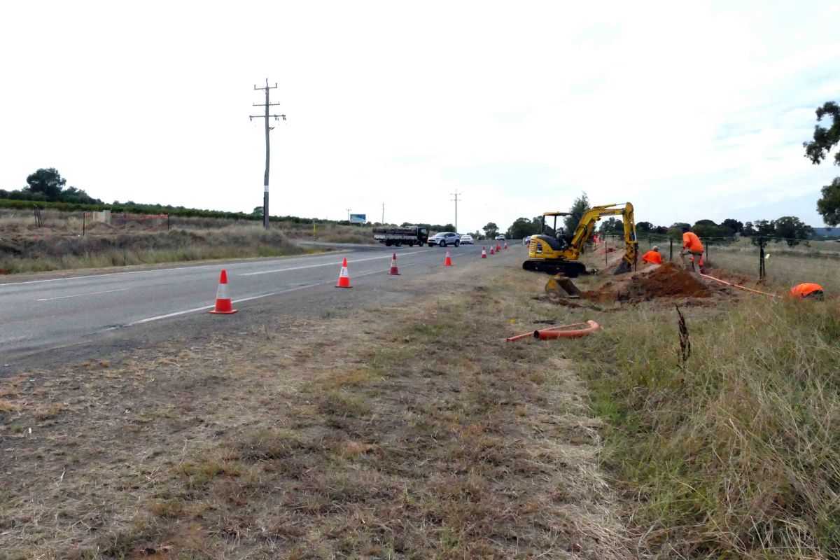 Works digging trenches and cabling for lights at intersection