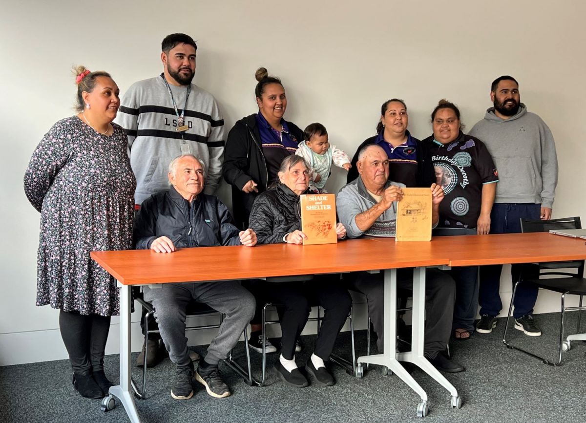 A group of family members pose for photos after a Family History talk. 