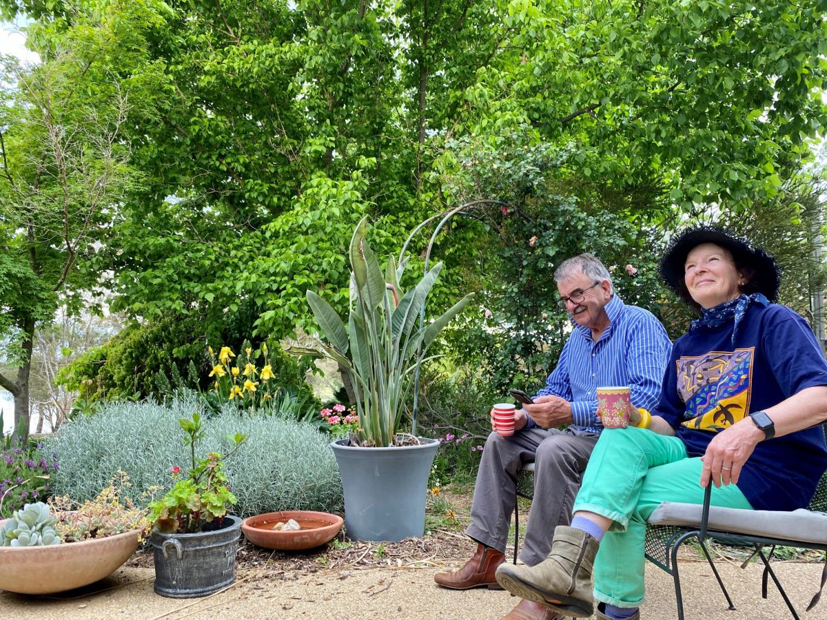 A senior couple sitting in a garden
