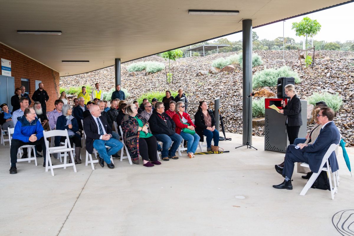 People seated under verandah of community centre