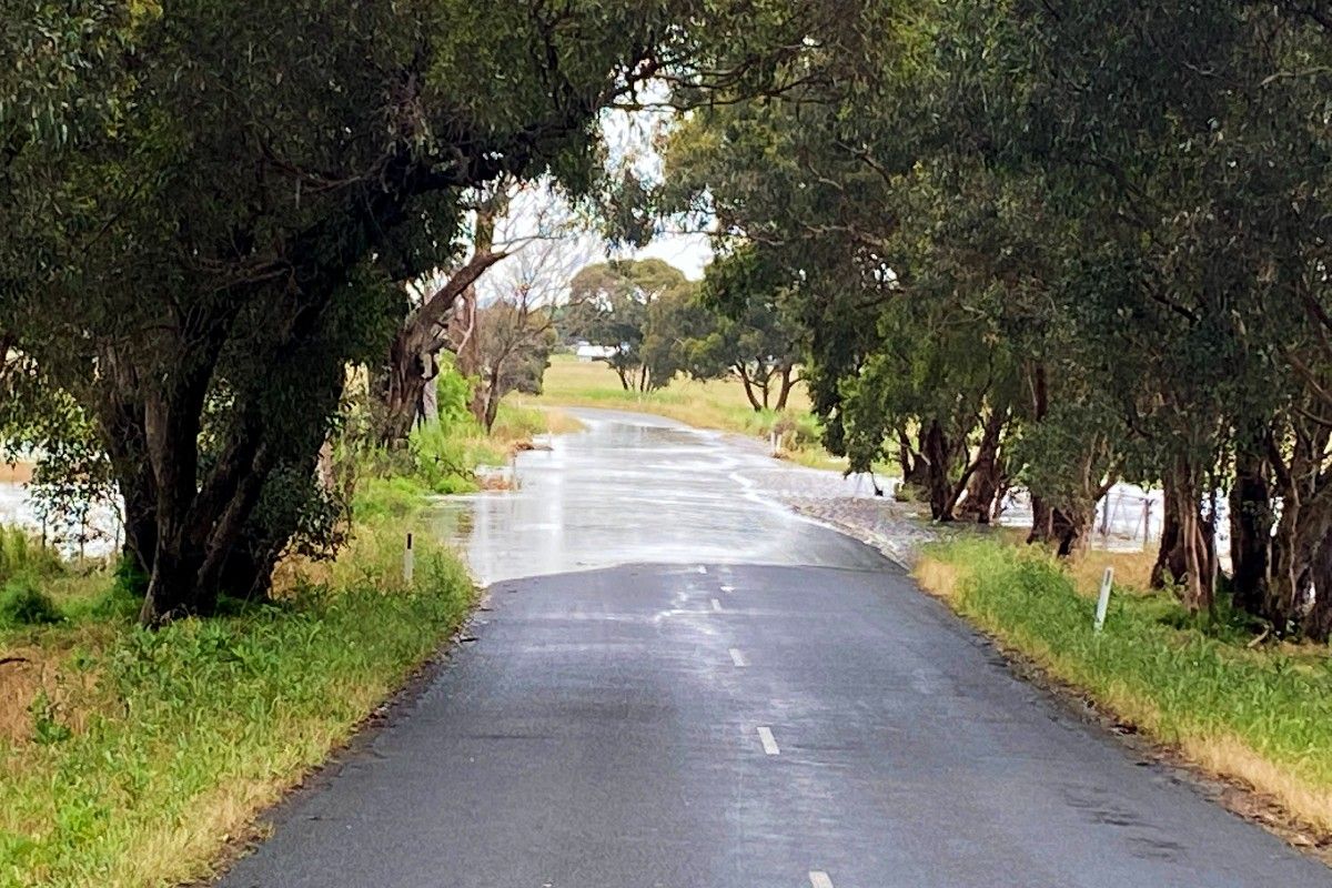 Water flowing across Bakers Lane