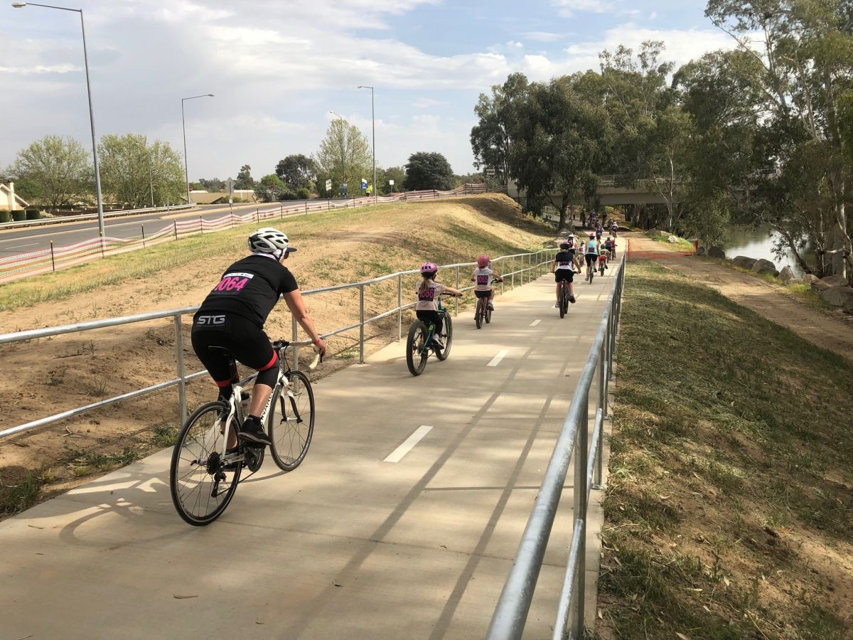 Cyclists of mix of age riding on shared pathway