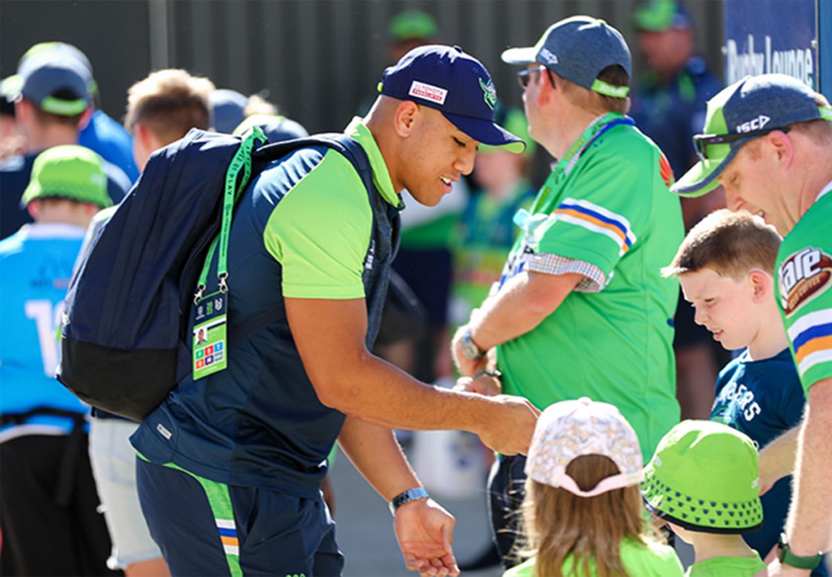 Raiders player Albert Hopoate signing autographs for kids
