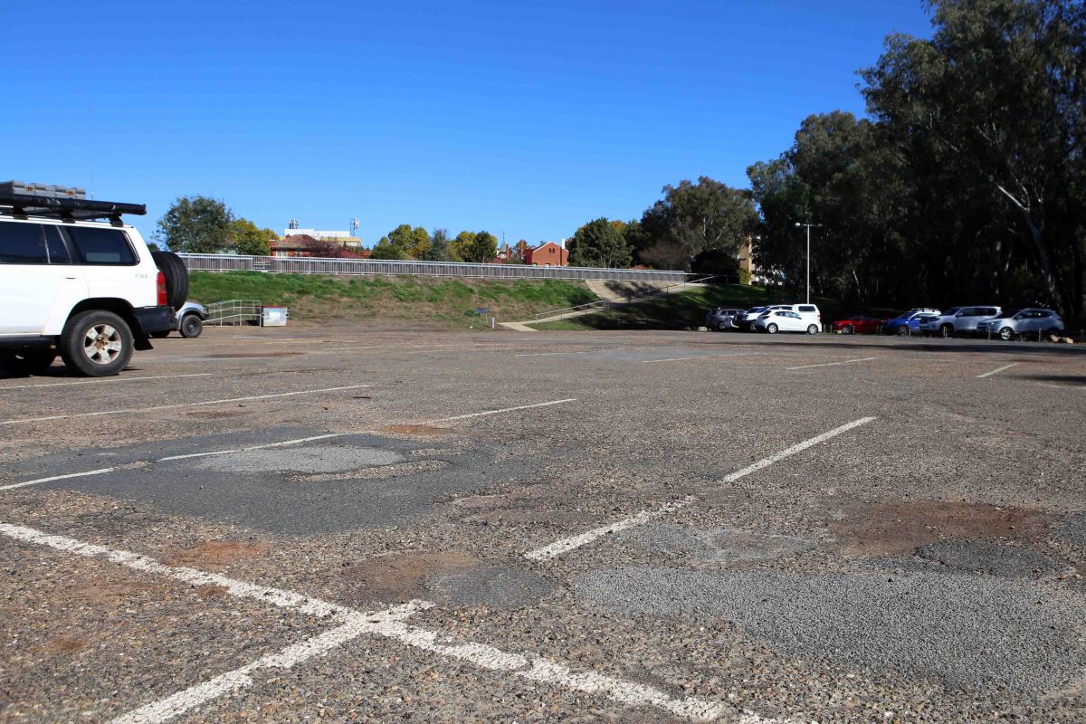 Carpark with potholes and patching on the surface