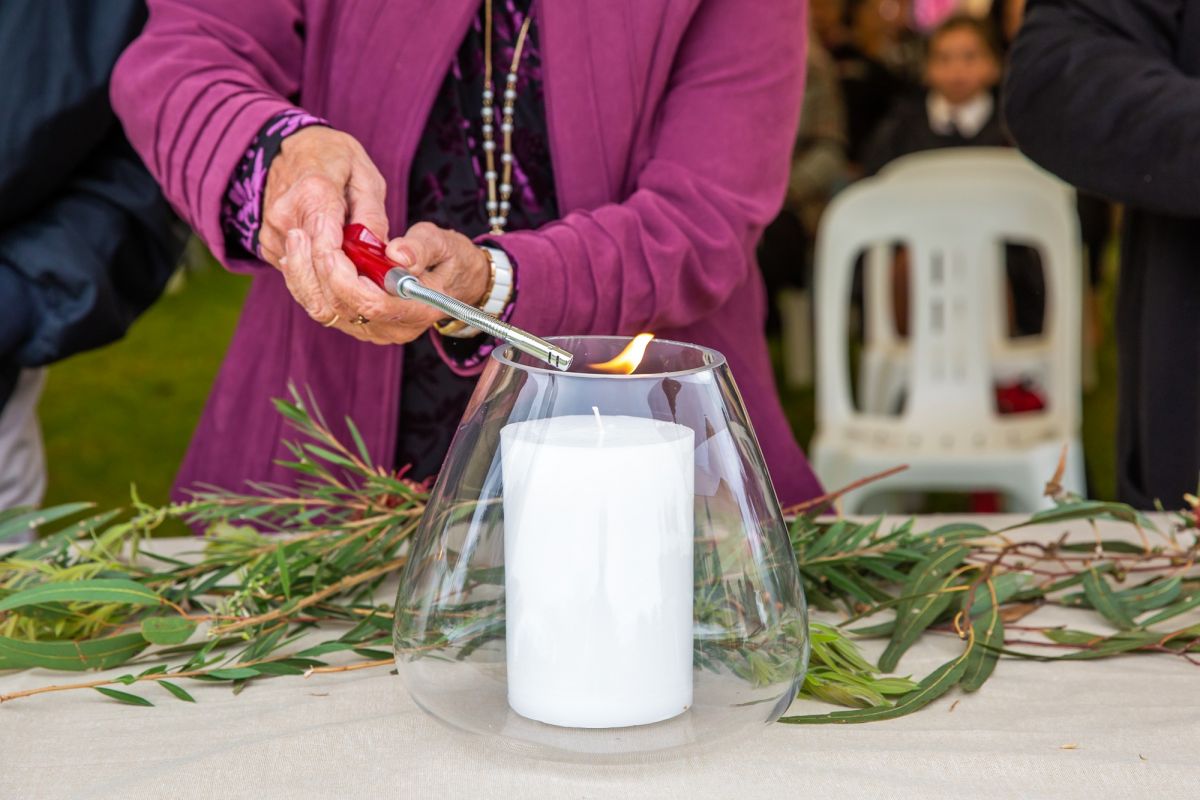 Women's handing holding lighter, lighting candle