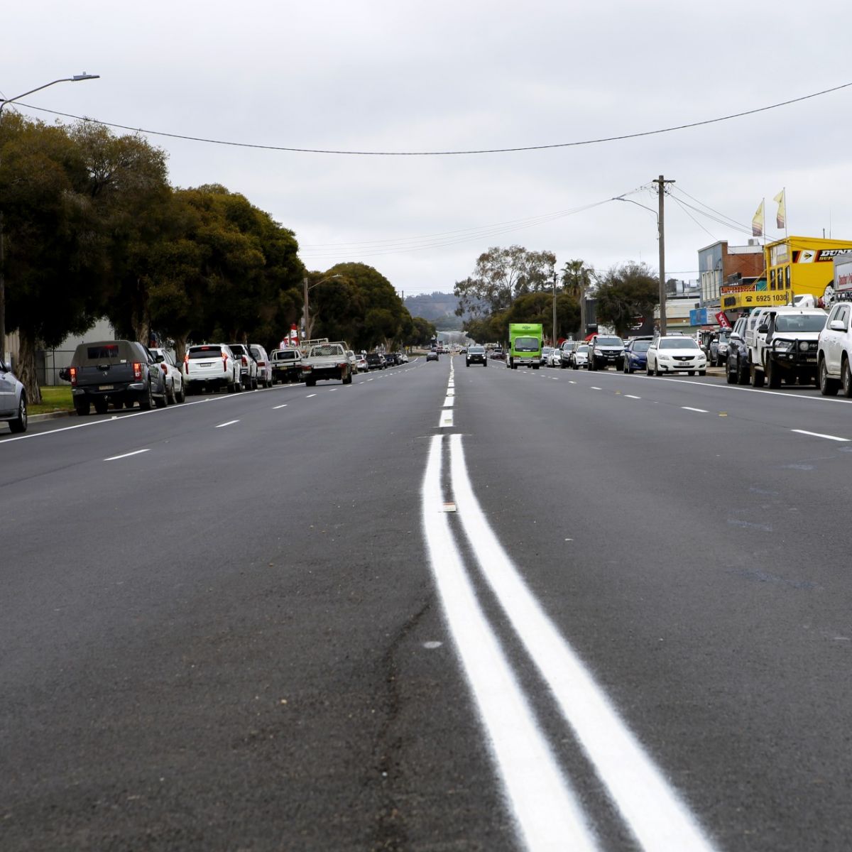 Line marking on rehabilitated road with vehicles travelling on it