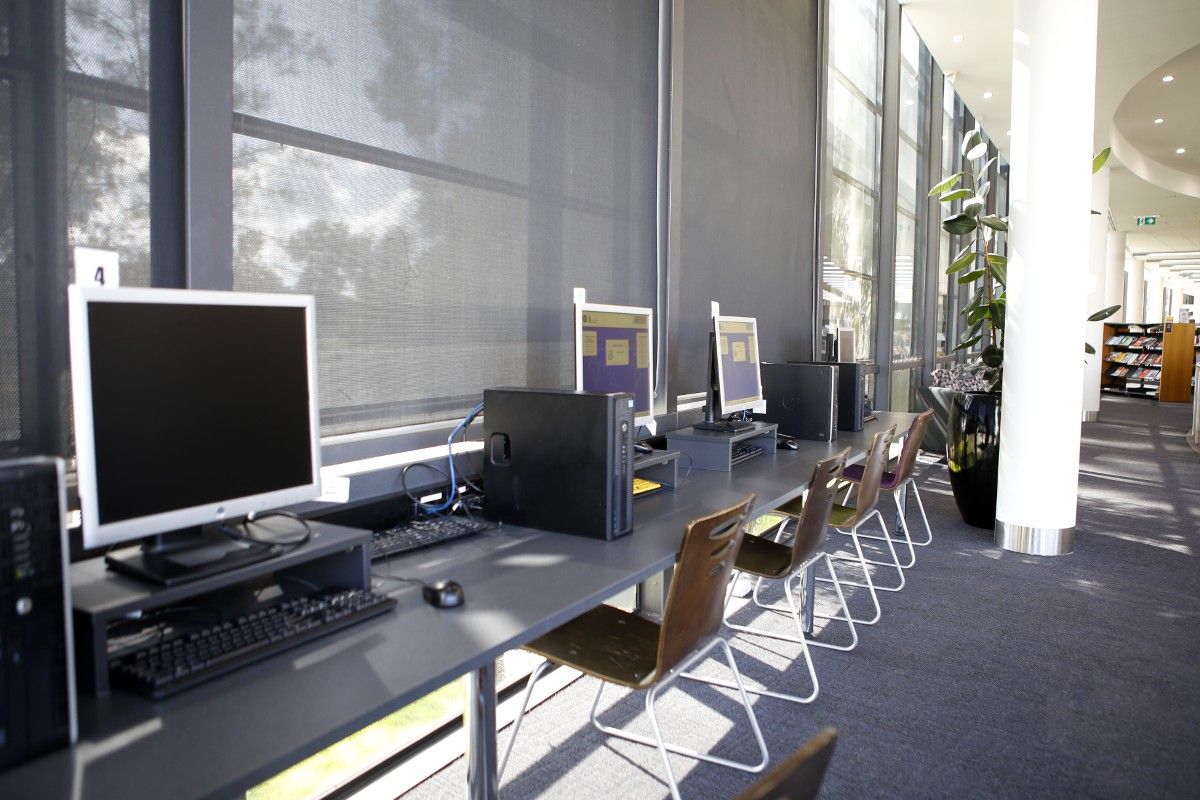 Computers on desk in library