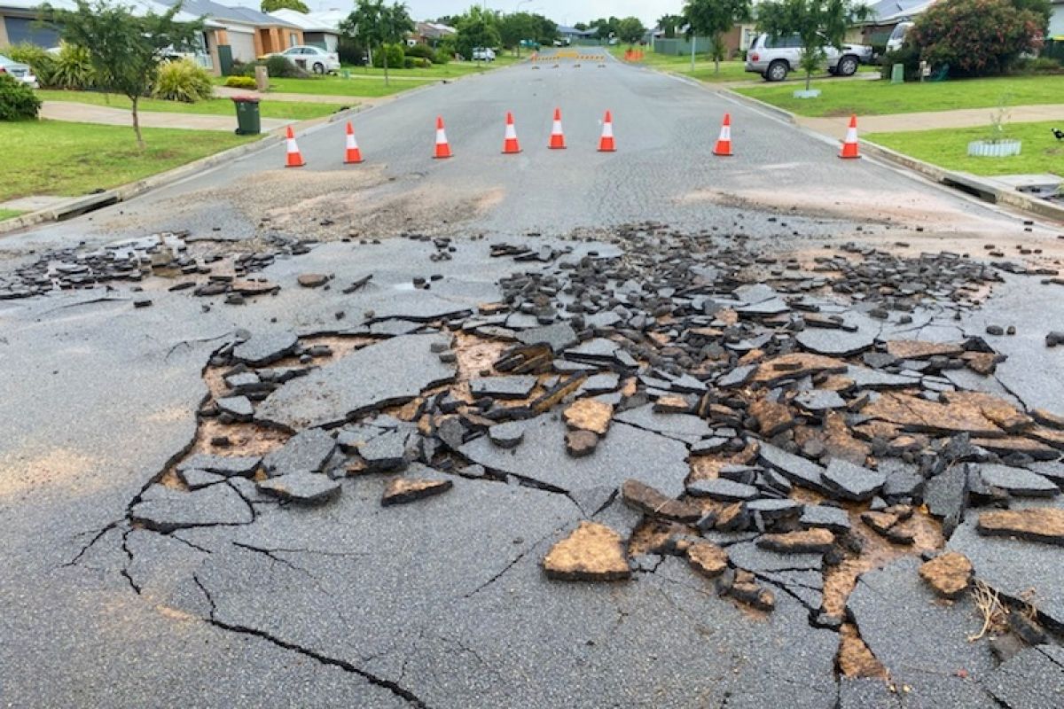 Road surface damaged by flash flooding in Melaleuca Drive in Forest Hill
