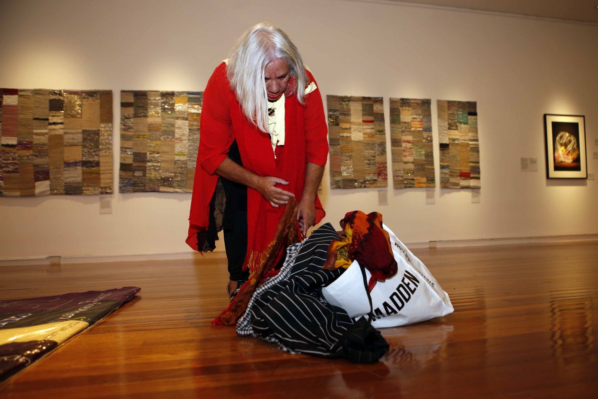 Aunty Cheryl Penrith at Art Gallery, looking through clothes in a bag