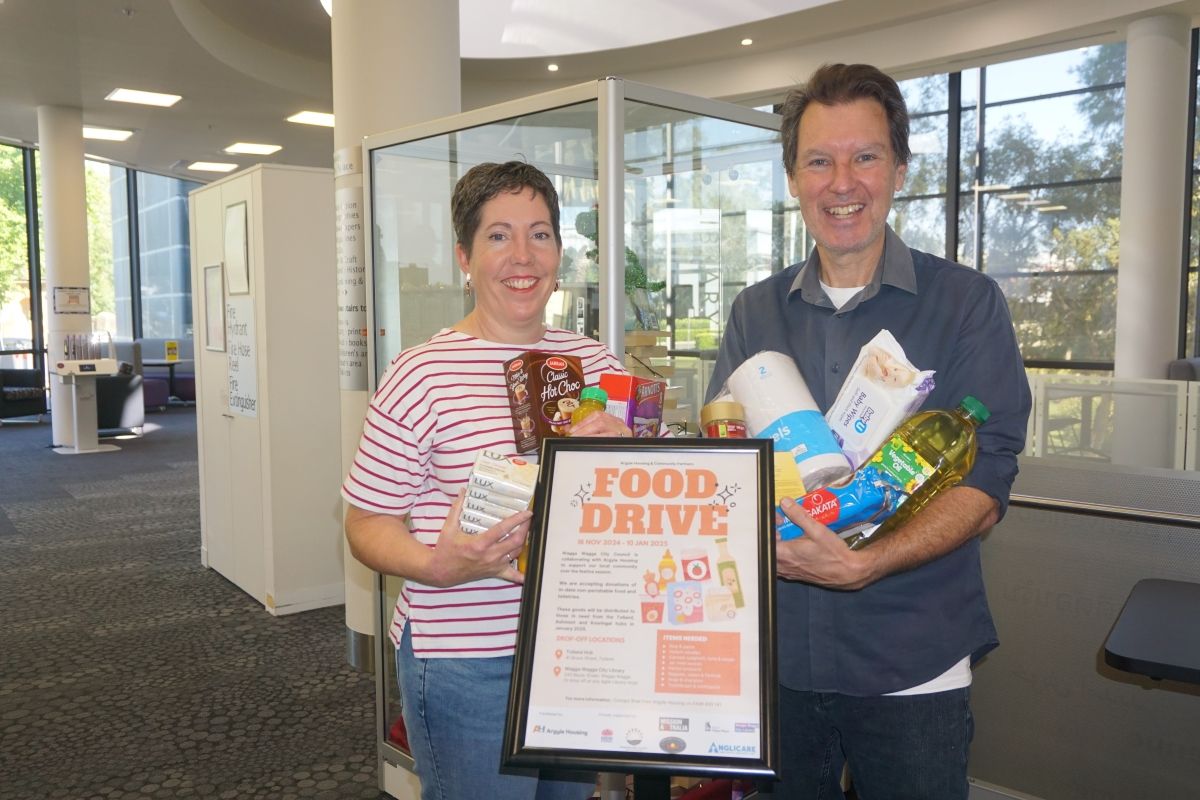 Wagga Wagga City Library's Outreach Services Team Leader Wendy Harper and Library Programs Officer Peter Casey with some of the goods for the 2024 Christmas Food Appeal. 