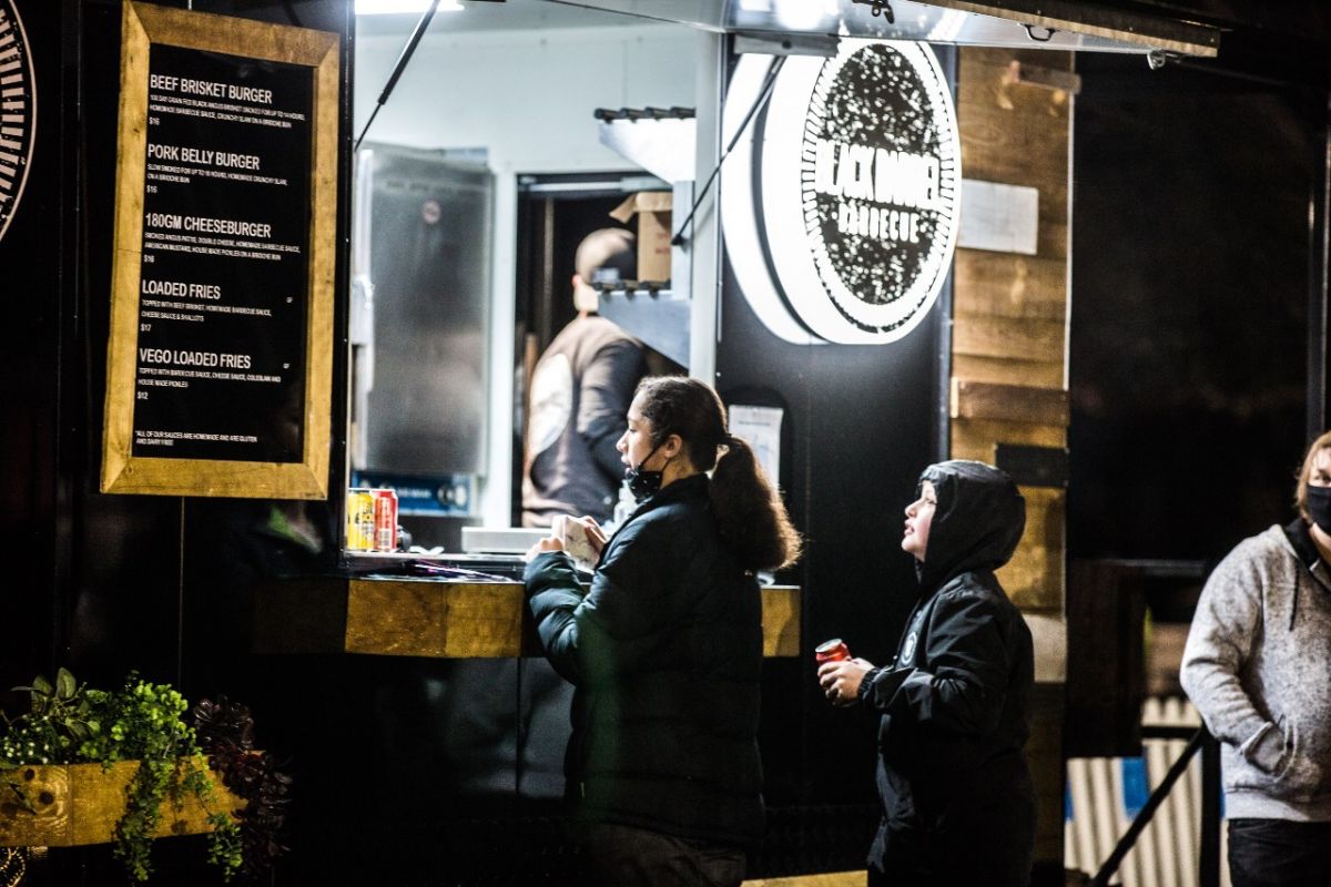 A woman ordering from a food van