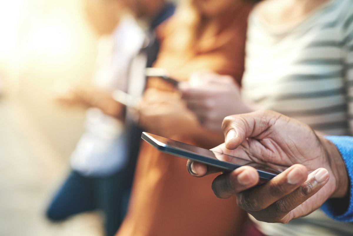 A close up of people's hands holding mobile phones