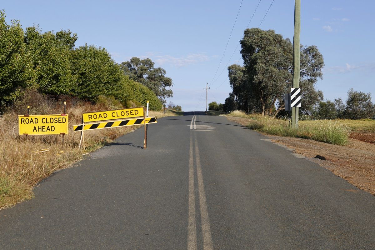 Road closed sign on side of sealed road - Dunns Road