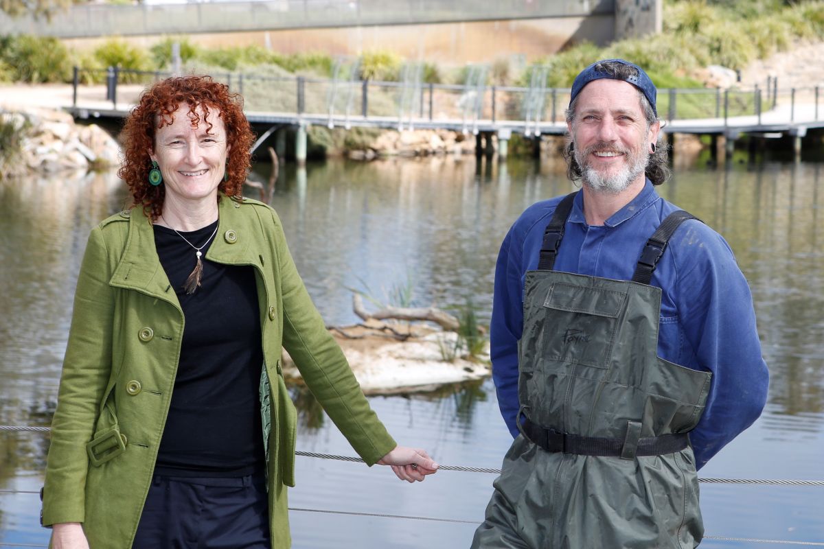 Project Manager Narelle Vogel (left) and artist Hayden Fowler (right) in front of the Wollundry Lagoon where the new exhibition 'Turtle Island' floats.