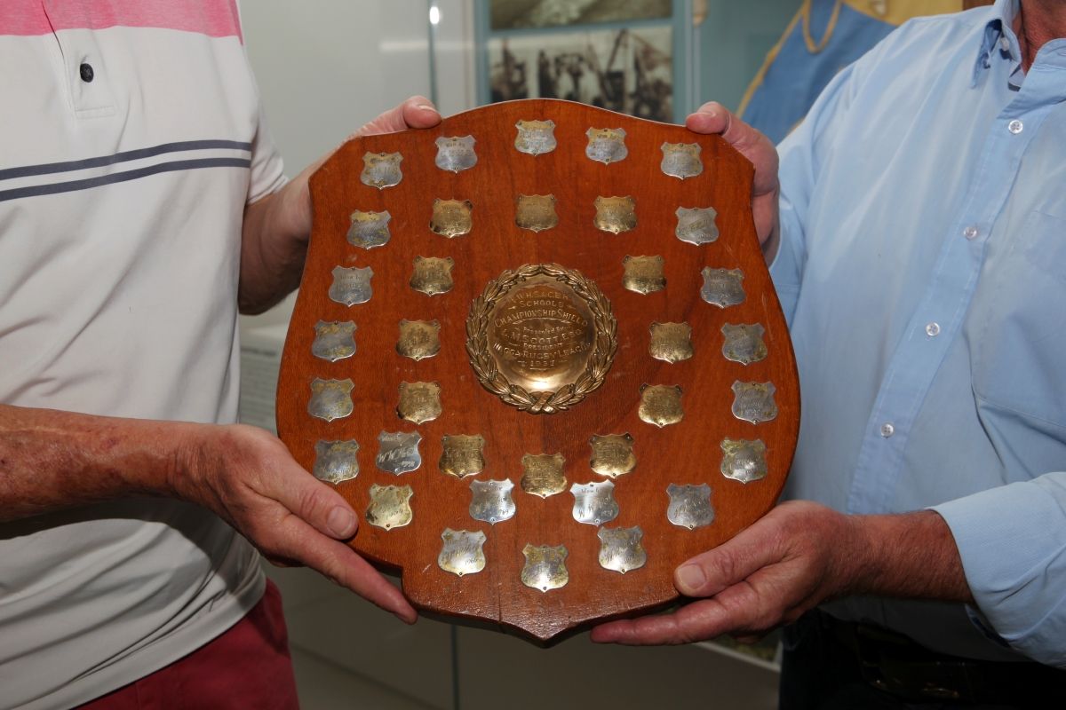 A close up of a large shield with several embellishments and engraving. 