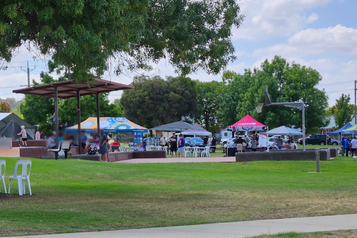 Wide view of park and skate park, with marquees in the background.