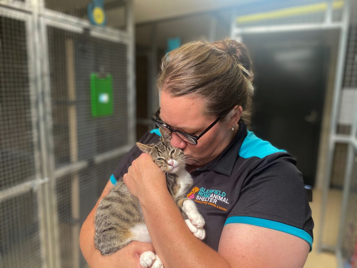 Woman kissing cat