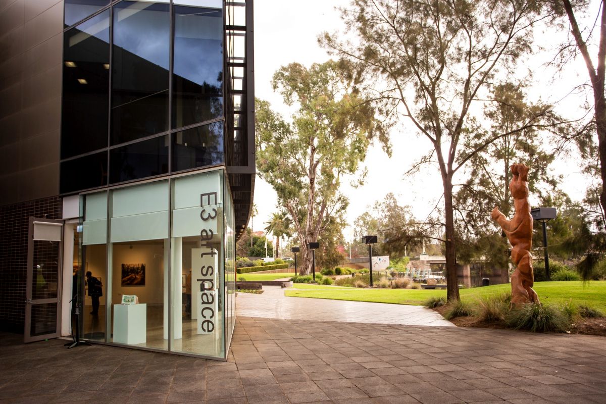 exterior of art gallery with lagoon in background