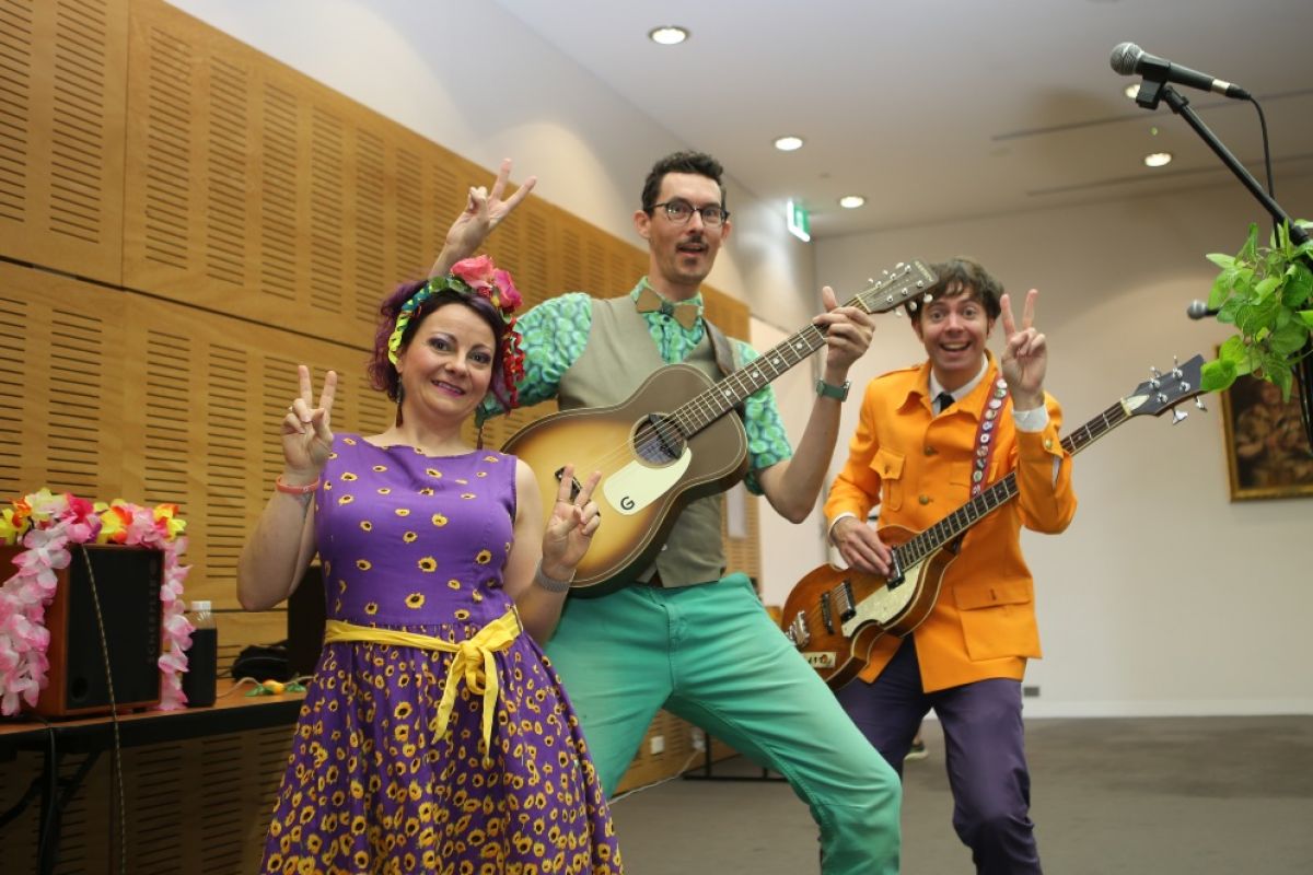 Female and two male musicians performing in Wagga Council Chambers