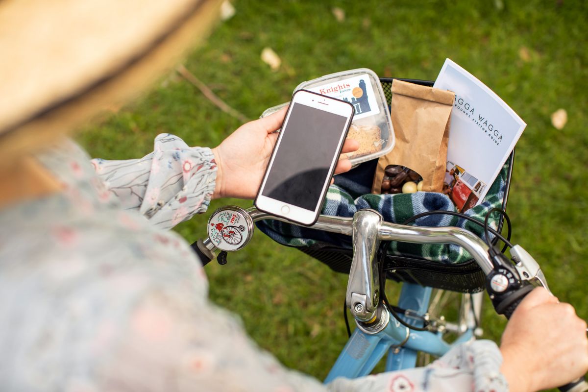 Top view of woman on bike looking at mobile phones