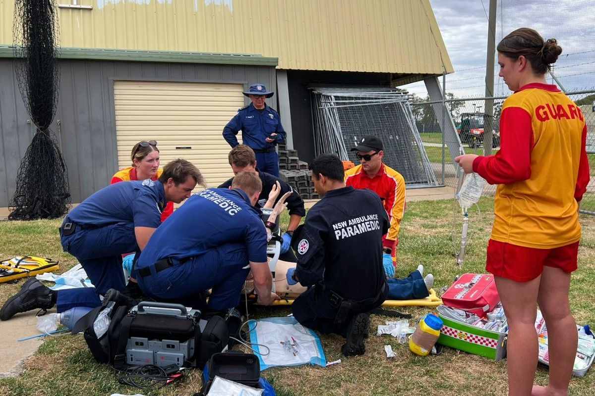 Paramedics and lifeguards and swimming teachers in action during an intensive water rescue and resuscitation simulation.