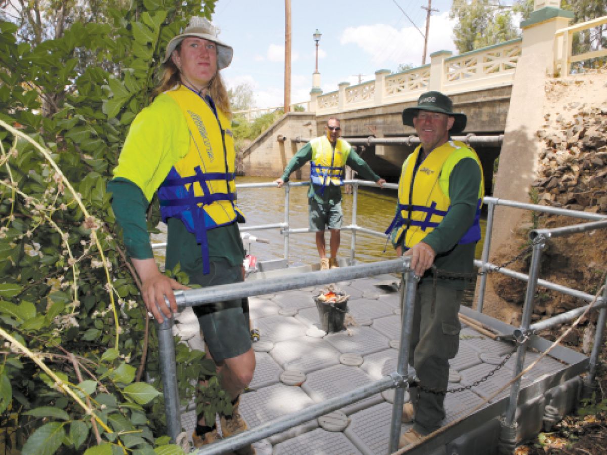  BRIDGE INSPECTIONS: Wagga City Council maintenance crew (from left) Angus McKenzie, Justin Kearnes and Iain Crossett aboard the new pontoon used to inspect two bridges across Wollundry Lagoon this week.