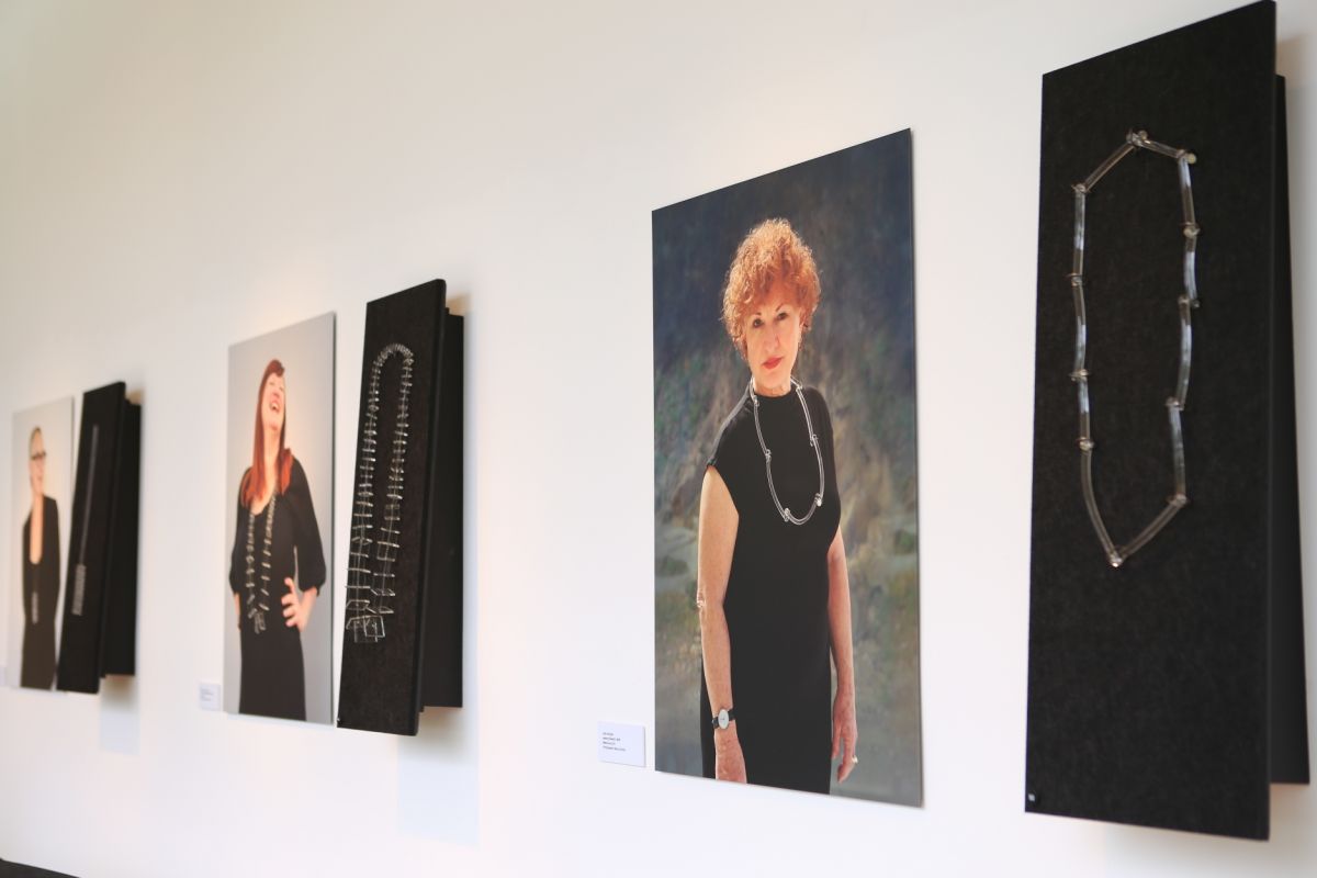 Photographic portraits of women wearing jewellery and jewellery displayed beside portraits